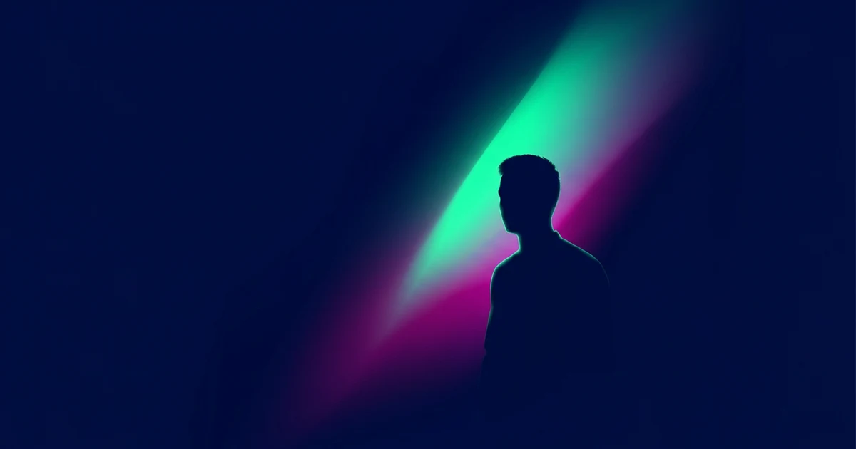 Dark silhouette of a man against a blue background with a diagonal beam of green and magenta light